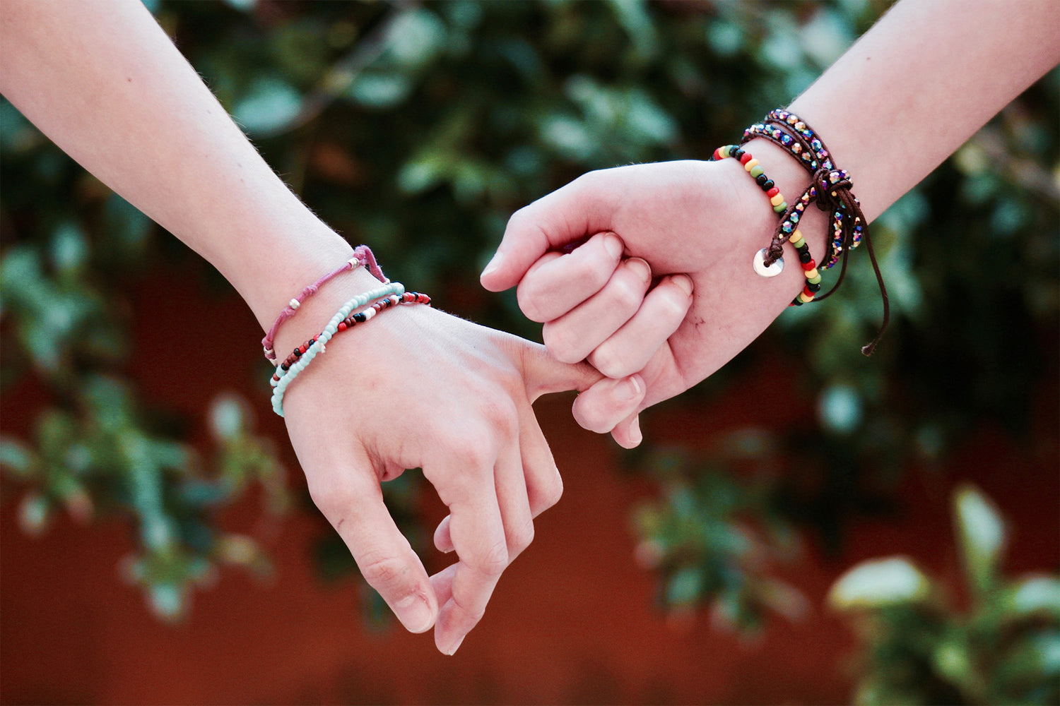 two friends sitting at a park bench